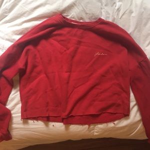 Orange/red  long sleeve shirt, that says freedom